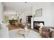 Bright living room with fireplace, hardwood floors, and a view into the dining area and kitchen at 1570 Flat Shoals Se Rd # 4, Atlanta, GA 30316
