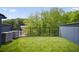 Rooftop terrace area with artificial grass, wrought iron safety railing and lush surrounding trees at 1570 Flat Shoals Se Rd # 4, Atlanta, GA 30316