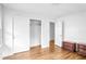 An empty bedroom with hardwood flooring featuring a closet and neutral colors at 3073 Henderson Mill Rd, Atlanta, GA 30341
