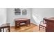 Bright bedroom featuring hardwood floors, a large window, and vintage furniture at 3073 Henderson Mill Rd, Atlanta, GA 30341