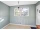 Dining area featuring light blue wainscoting, vintage chandelier, and neutral floors at 3073 Henderson Mill Rd, Atlanta, GA 30341