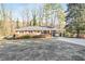 Charming brick home featuring a covered carport and a well-maintained front yard at 3073 Henderson Mill Rd, Atlanta, GA 30341