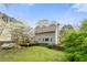 Back exterior showcasing a deck, lush lawn, and mature trees at 3097 Sycamore Ln, Marietta, GA 30066