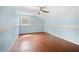 Empty bedroom featuring blue walls, hardwood floors and natural light at 3097 Sycamore Ln, Marietta, GA 30066