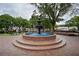 A three-tiered brick fountain situated in a park-like setting with trees and benches at 3097 Sycamore Ln, Marietta, GA 30066