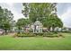 A park gazebo surrounded by manicured green lawn and decorative flowerbeds at 3097 Sycamore Ln, Marietta, GA 30066