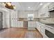 Kitchen featuring white cabinets, granite countertops, stainless steel appliances, and hardwood floors at 3097 Sycamore Ln, Marietta, GA 30066