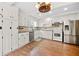 Kitchen featuring white cabinets, stainless steel appliances, and hardwood floors at 3097 Sycamore Ln, Marietta, GA 30066