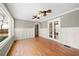 Living room featuring hardwood floors, wainscoting, crown molding, and natural light from large windows at 3097 Sycamore Ln, Marietta, GA 30066