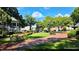 Community park featuring brick pathways, benches, mature trees and lush green spaces at 3097 Sycamore Ln, Marietta, GA 30066
