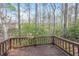 Wooden backyard deck surrounded by trees and lush greenery offering a private outdoor space at 3684 Wittenburg Ct, Decatur, GA 30034