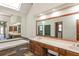 Large bathroom featuring a skylight, soaking tub, a double sink vanity, and large mirrors at 3684 Wittenburg Ct, Decatur, GA 30034