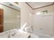 Bright bathroom featuring a tub and shower with tile surround at 3684 Wittenburg Ct, Decatur, GA 30034