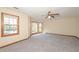 Spacious bedroom with plush carpeting, a ceiling fan, and natural light from multiple windows at 3684 Wittenburg Ct, Decatur, GA 30034