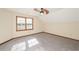 A well-lit room featuring a ceiling fan, neutral walls, plush carpet, and natural lighting at 3684 Wittenburg Ct, Decatur, GA 30034