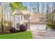 Charming home with a two-car garage, bay window, manicured lawn, and mature trees at 3684 Wittenburg Ct, Decatur, GA 30034