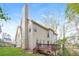 View of the house showing the chimney, large windows, and back deck at 3684 Wittenburg Ct, Decatur, GA 30034