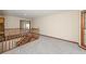 Hallway with wood railing, neutral walls and plush carpet, leading to multiple rooms at 3684 Wittenburg Ct, Decatur, GA 30034