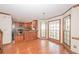 Inviting kitchen area featuring hardwood floors, modern appliances, and a breakfast nook with many windows at 3684 Wittenburg Ct, Decatur, GA 30034