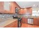 Modern kitchen with stainless steel appliances, granite countertops, tile backsplash, and hardwood floors at 3684 Wittenburg Ct, Decatur, GA 30034