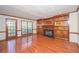 Bright living room featuring hardwood floors, a fireplace, built-in shelving, and access to the deck at 3684 Wittenburg Ct, Decatur, GA 30034