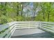 View of a wooden deck overlooking lush green trees and foliage at 4490 Thornwood Trl, Stone Mountain, GA 30083