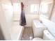 Clean and bright bathroom with white tile, a marble vanity, and ample natural light at 819 Venetta Nw Pl, Atlanta, GA 30318