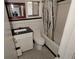 Cozy bathroom featuring black and white checkered floors, tiled walls, and updated vanity at 819 Venetta Nw Pl, Atlanta, GA 30318