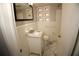 A bright white bathroom with a marble sink, square mirror, and neutral tile floors at 819 Venetta Nw Pl, Atlanta, GA 30318