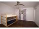 This bedroom offers dark hardwood flooring, natural light, and a closet perfect for storing items at 819 Venetta Nw Pl, Atlanta, GA 30318