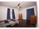This cozy bedroom features hardwood floors, ceiling fan, natural light, and wooden furniture at 819 Venetta Nw Pl, Atlanta, GA 30318