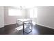 Cozy dining room features hardwood floors, a modern table, and abundant natural light at 819 Venetta Nw Pl, Atlanta, GA 30318