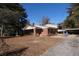 View of the brick home with a long driveway, covered parking, and expansive yard at 819 Venetta Nw Pl, Atlanta, GA 30318