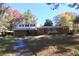Charming two-story home with a brick facade and a spacious front yard surrounded by mature trees at 819 Venetta Nw Pl, Atlanta, GA 30318