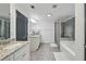 Bright primary bathroom with granite counters, dual sinks, and a separate tub and shower at 1895 Weston Ln, Tucker, GA 30084