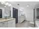 Bright primary bathroom with granite counters, dual sinks, and a separate tub and shower at 1895 Weston Ln, Tucker, GA 30084