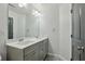 Spacious bathroom with double sink vanity, gray cabinets, and modern lighting fixtures at 1895 Weston Ln, Tucker, GA 30084