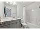 Bathroom features a shower-tub combination, grey cabinets and a white countertop vanity at 1895 Weston Ln, Tucker, GA 30084
