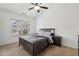 Neutral bedroom featuring a queen bed, ceiling fan, and a window with natural light at 1895 Weston Ln, Tucker, GA 30084