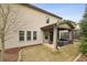 Exterior view of the home with a covered patio and outdoor seating area in the backyard at 1895 Weston Ln, Tucker, GA 30084