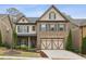 Charming two-story home featuring a brick facade and a two-car garage at 1895 Weston Ln, Tucker, GA 30084