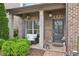Inviting front porch with brick detail, cozy seating, and stylish decor at 1895 Weston Ln, Tucker, GA 30084