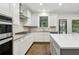 Bright kitchen with stainless steel appliances, granite countertops, and ample cabinet space at 1895 Weston Ln, Tucker, GA 30084