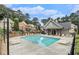 Community pool area with ample lounge chairs, clubhouse, and lush landscaping at 1895 Weston Ln, Tucker, GA 30084