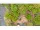 Overhead view of the property with lush trees, parking, and nearby commercial spaces at 484 Lorene Sw Dr, Marietta, GA 30060
