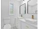 Bright bathroom featuring double sinks with gold faucets, and black framed mirrors at 484 Lorene Sw Dr, Marietta, GA 30060