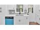 Charming kitchen featuring white cabinets, stainless steel sink, and modern fixtures at 484 Lorene Sw Dr, Marietta, GA 30060