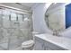 Modern bathroom with marble tile, glass shower, and updated vanity at 921 Creekdale Dr, Clarkston, GA 30021