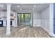 Open dining area featuring hardwood floors, sliding glass doors to the deck, and adjacent kitchen at 921 Creekdale Dr, Clarkston, GA 30021