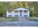 Charming two-story home with a landscaped yard and a welcoming front porch framed by stone columns at 921 Creekdale Dr, Clarkston, GA 30021